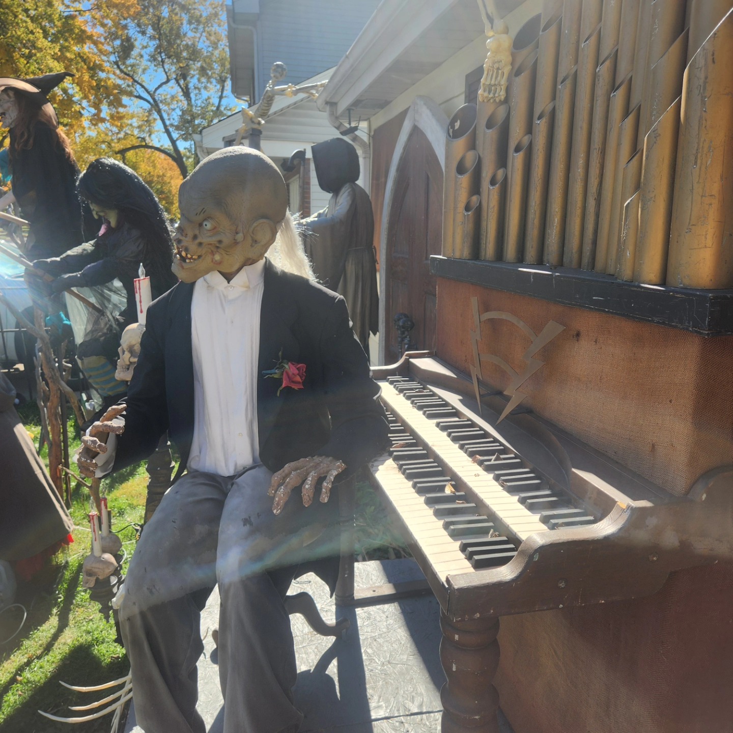 Close-up of the skeletal organist in a black jacket beside the organ keyboard — Hills of Unrest, October 2024.