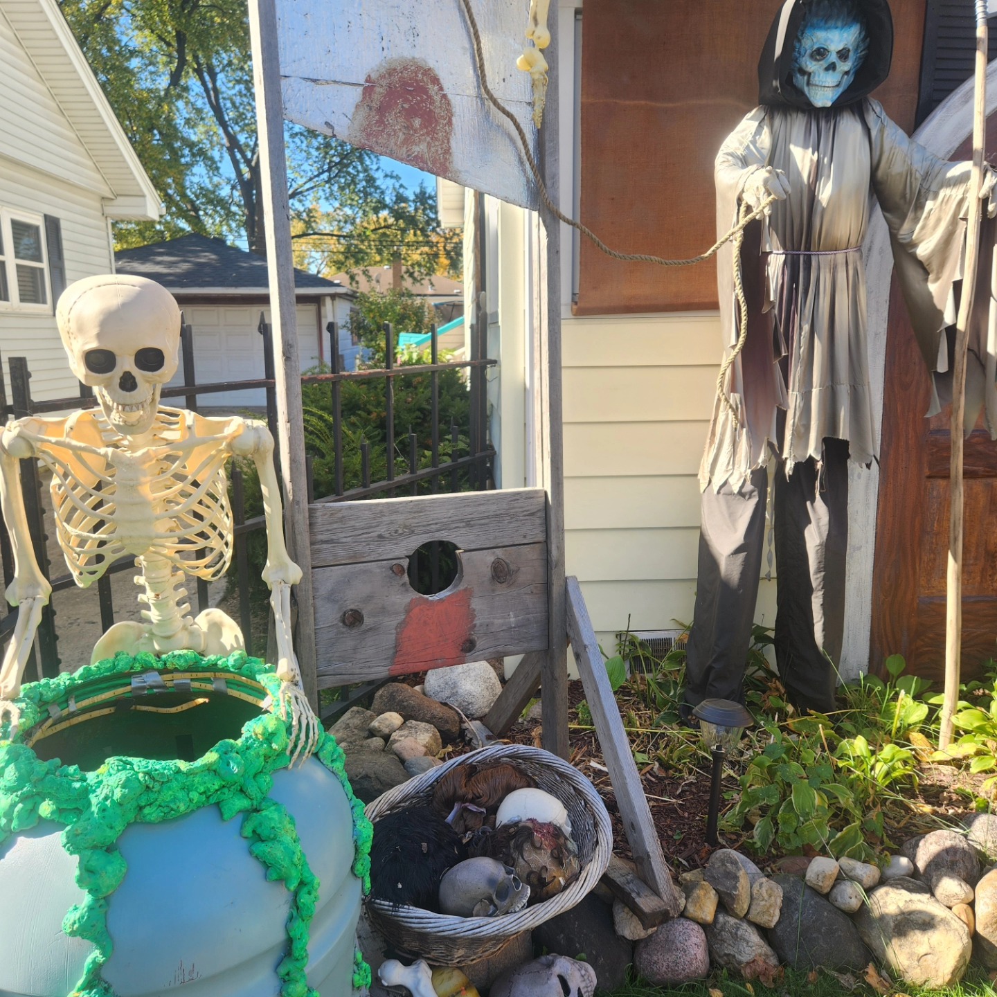 A skeleton, cauldron, skulls and a hooded reaper among the cemetery scenery — Hills of Unrest, October 2024.