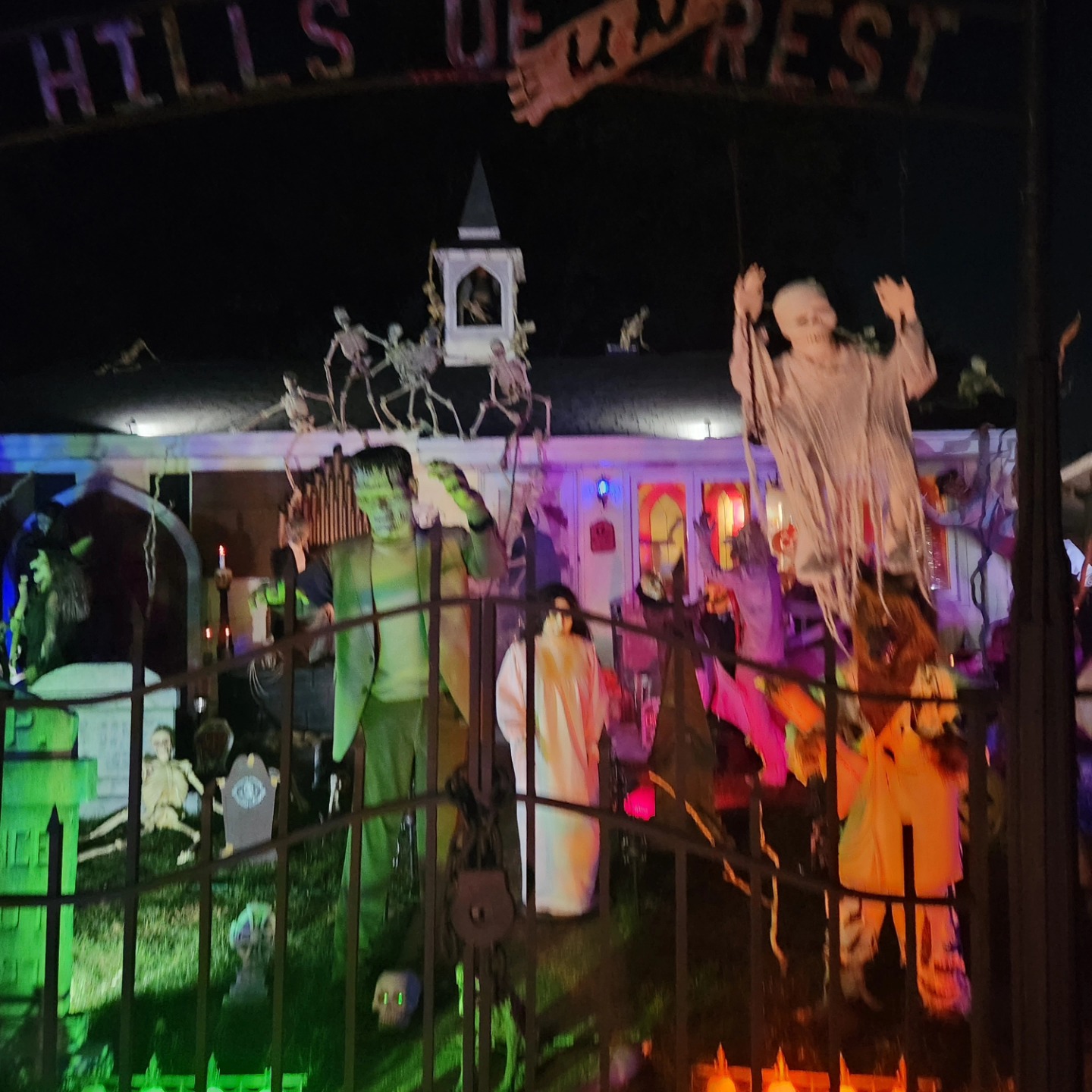 The real Hills of Unrest bell tower and cemetery illuminated at night, photographed in October 2024